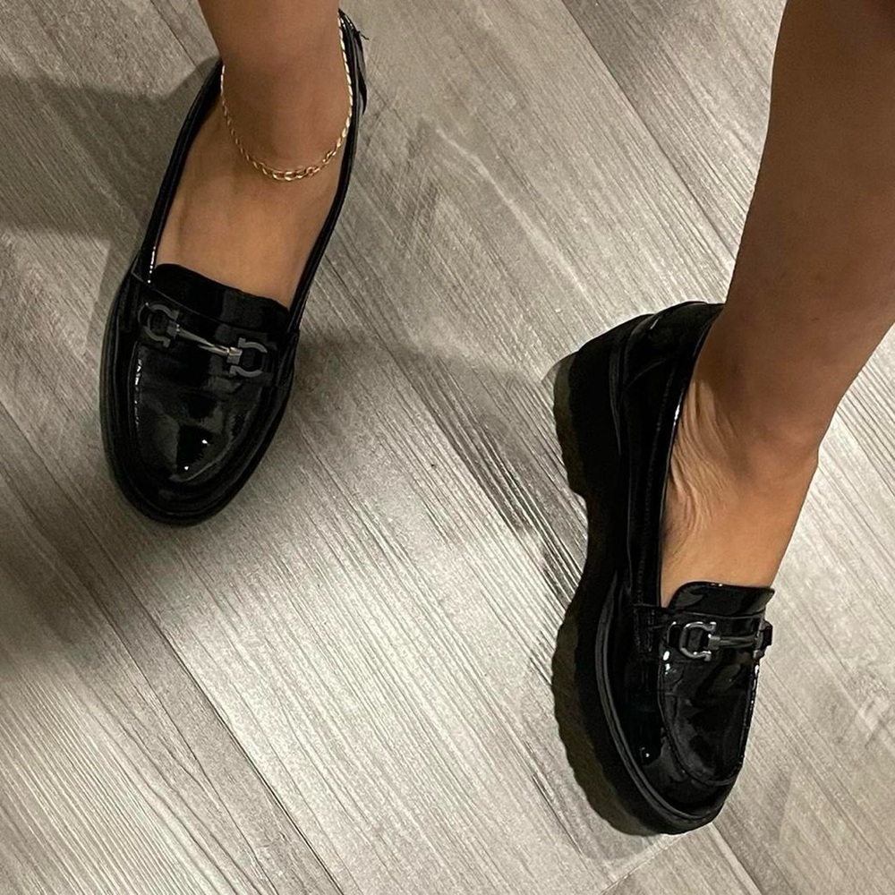 Black patent platform loafers with silver hardware.
